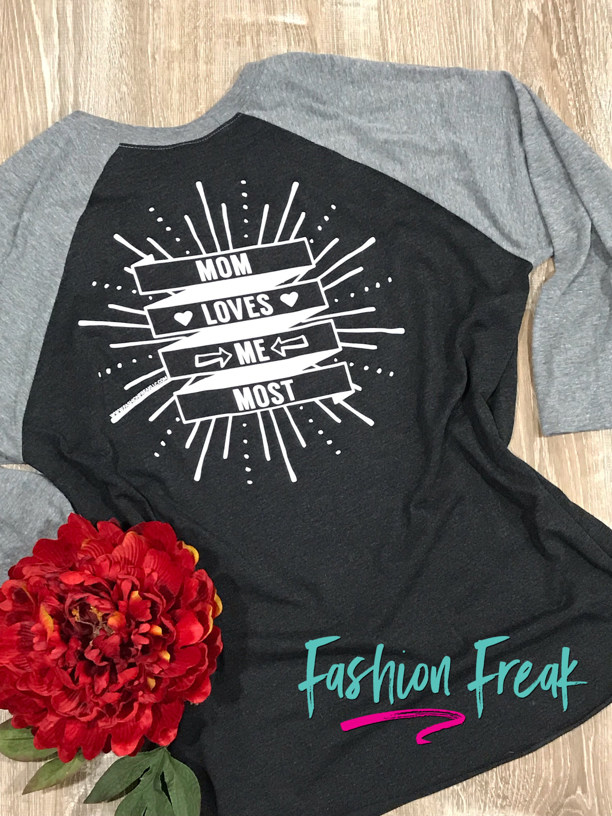 Mom Loves Me Most | Black &amp; Grey Raglan Baseball Tee | Fashion Freak LLC | Apple Valley, MN
